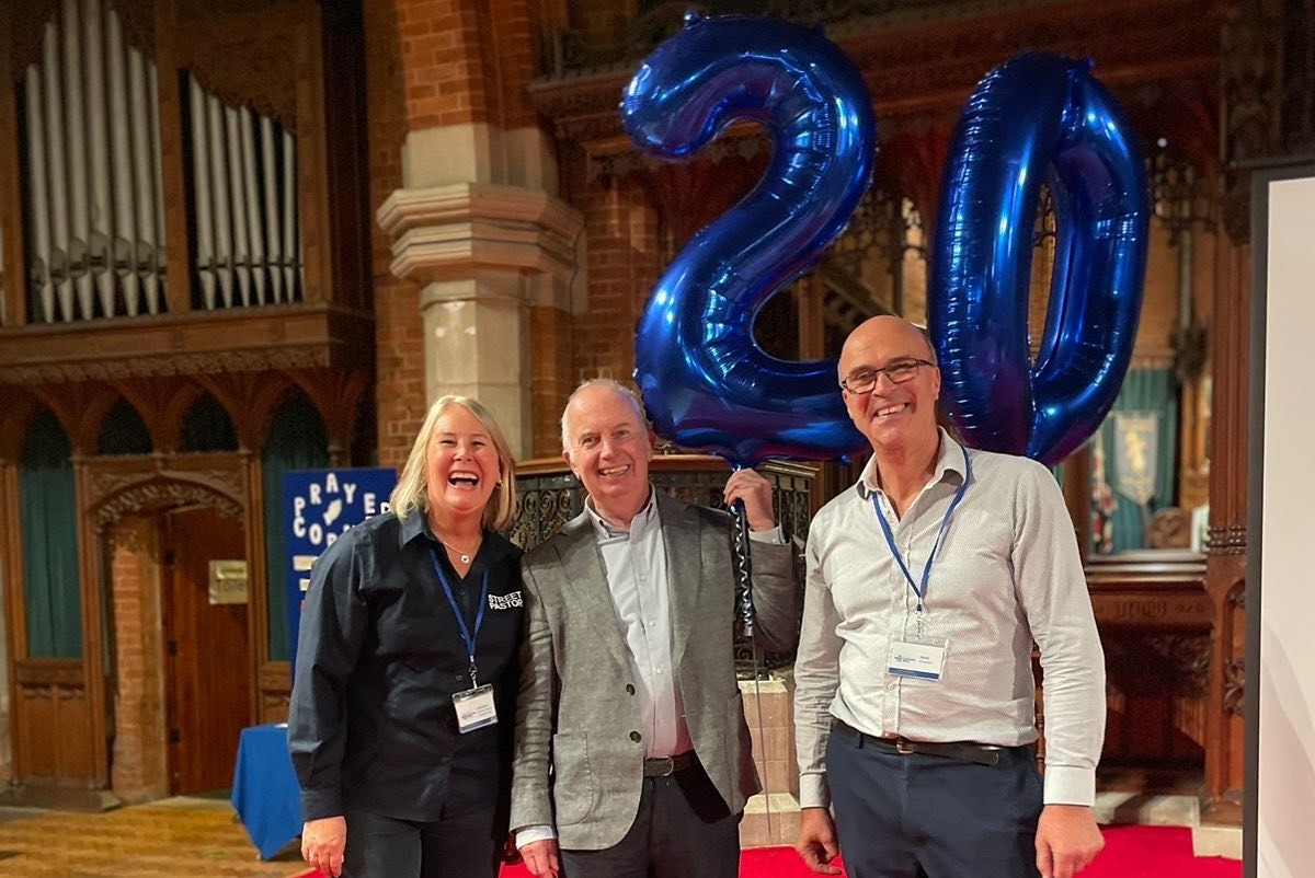 Sutton Community Works 20th anniversary with Leader of the Council, Councillor Barry Lewis (middle) and Street Pastors. Barry is holding a large blue '20' balloon.