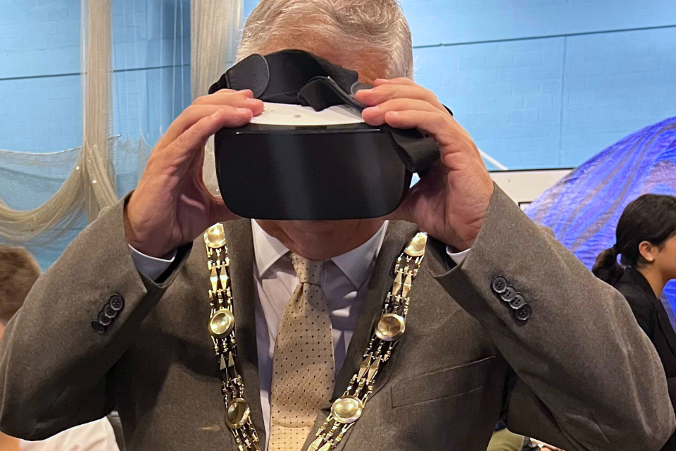 Mayor Cllr Colin Stears placing a VR headset on his face