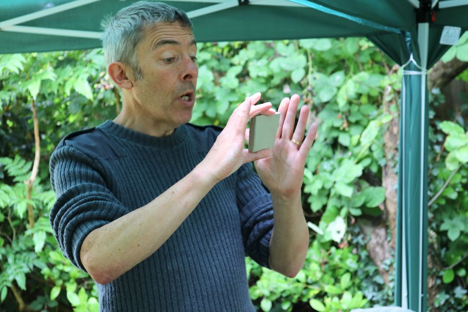 Doug Shaw holding a square of clay