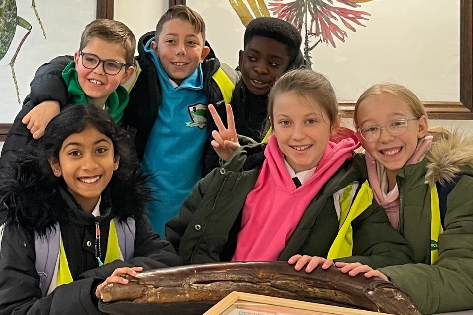 Six primary school students smiling towards the viewer