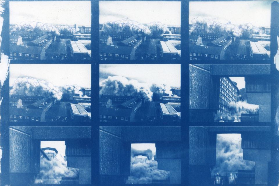 A blue-tinted grid of 9 image panels showing several factory houses with smoke billowing out into the sky