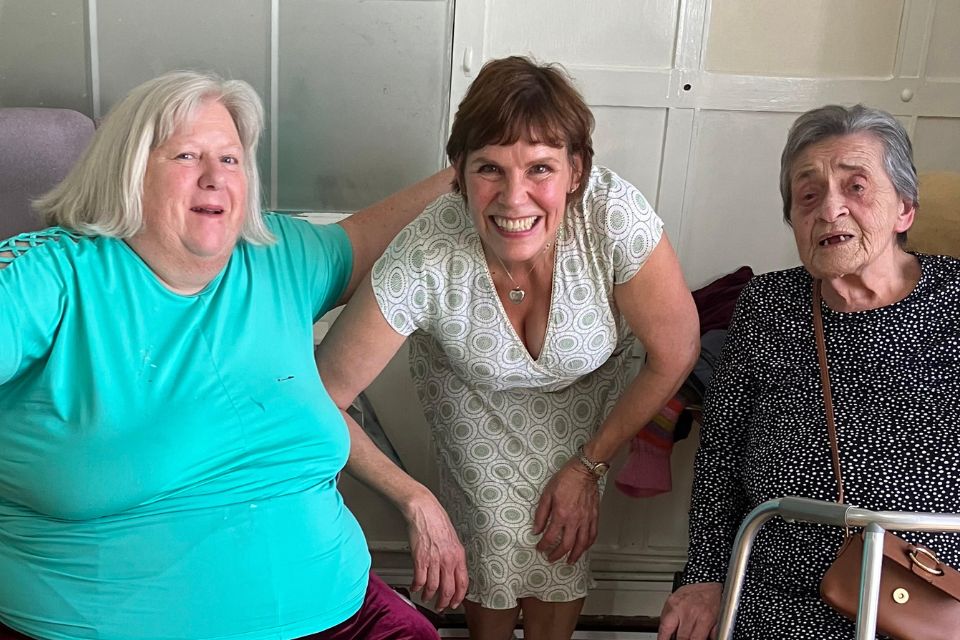 Melanie Dean with two female residents in a care home