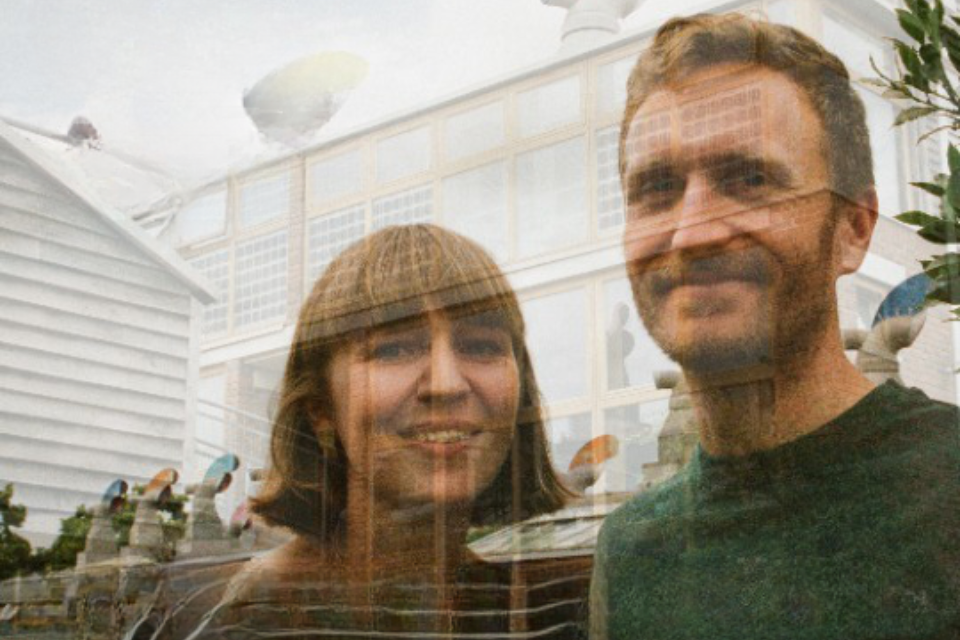 A man and woman projected onto a building