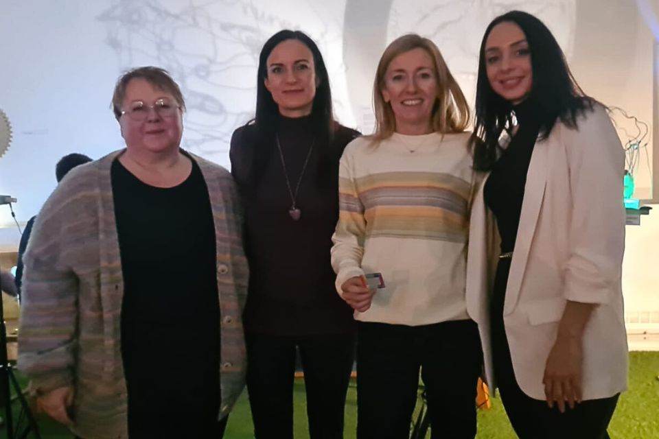Four women smiling towards the camera