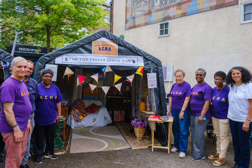 The members of the African Caribbean Heritage association stood together in front of a temporary shed on Sutton High Street's Trinity Square