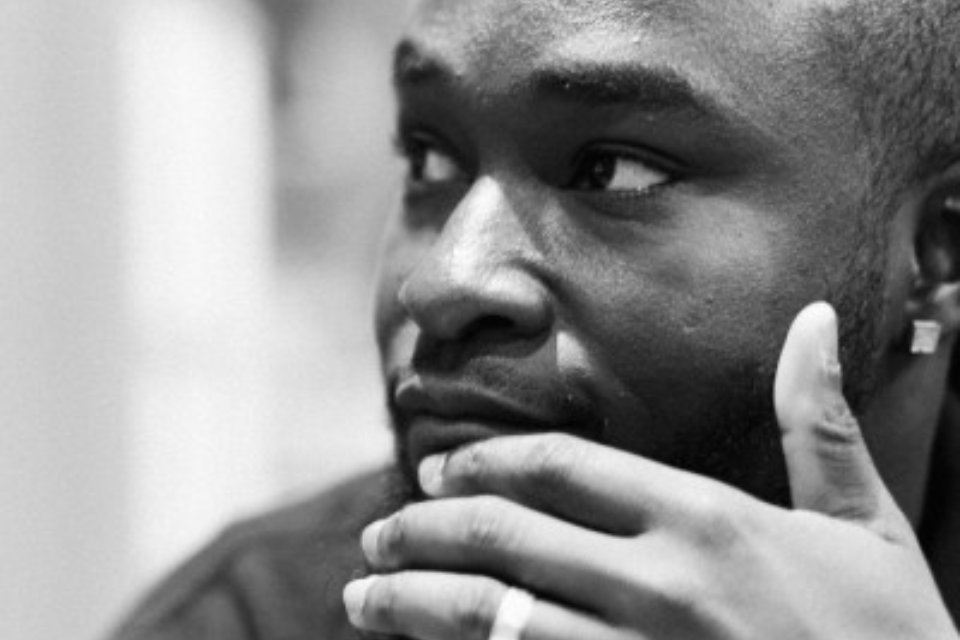 A black and white image of a young black male