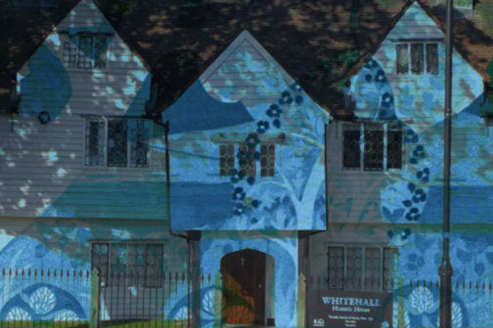 Whitehall Historic House lit with a blue hue